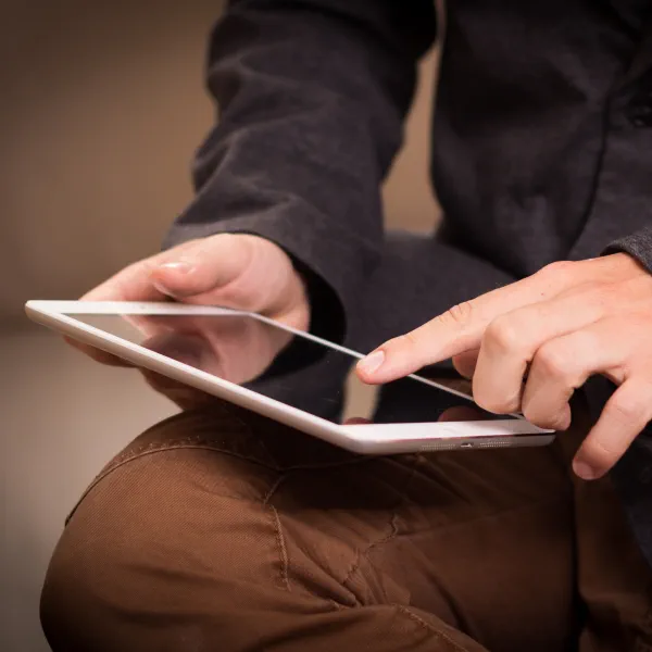 General Enquiries A person using a tablet device